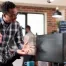 Two coworkers looking at a dual monitor and discussing cybersecurity in their workplace